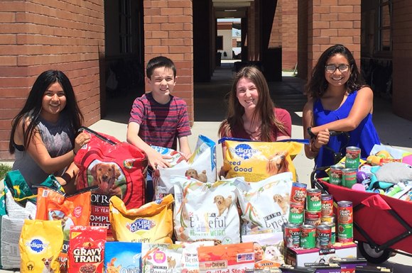 Lemoore University Charter School students with some of the food they colllected: (L to R) Esbeyda Lopez, Maverick Lucas, Lilly Elliot, and Victoria Gonzalez.